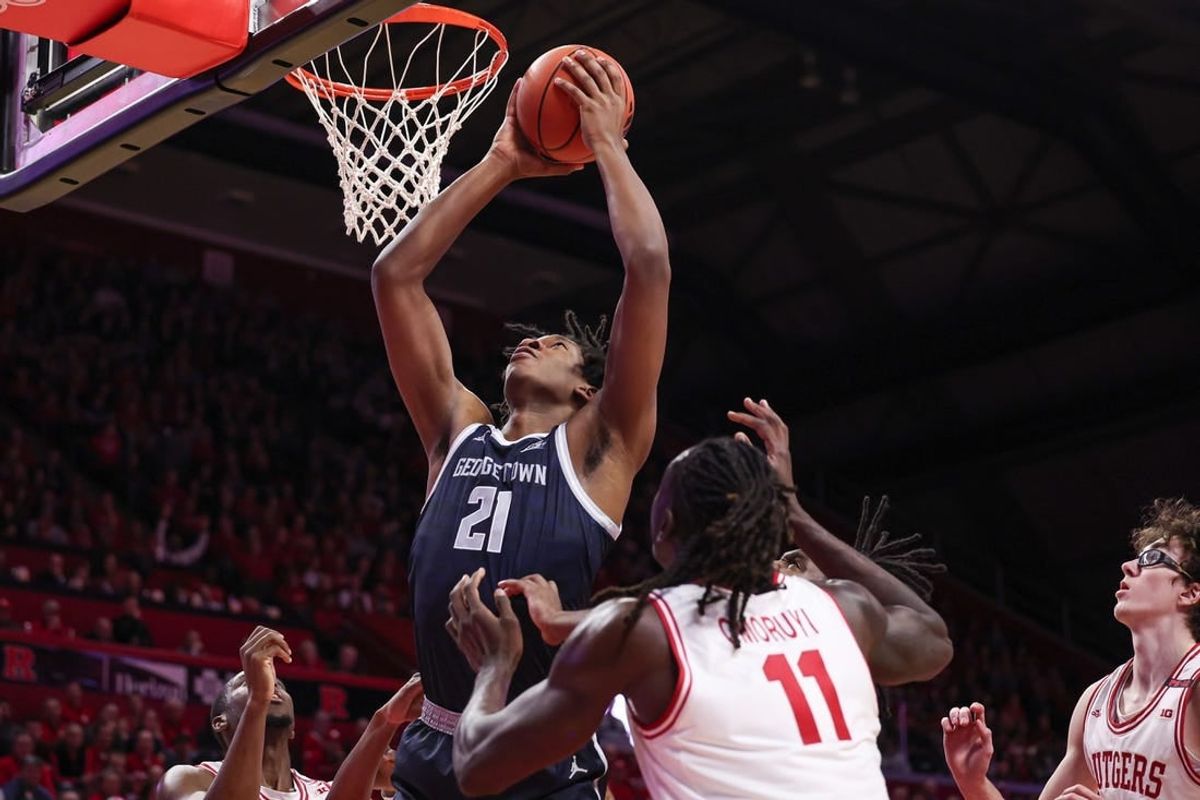 Nov 15, 2023; Piscataway, New Jersey, USA; Georgetown Hoyas center Ryan Mutombo (21) goes to the basket in front of Rutgers Scarlet Knights center Clifford Omoruyi (11) and guard Gavin Griffiths (10) during the first half at Jersey Mike's Arena.