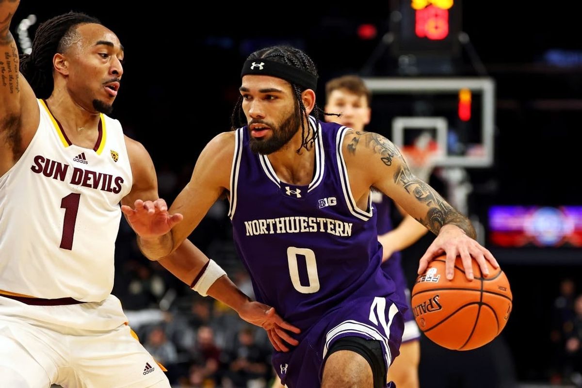 Dec 20, 2023; Phoenix, Arizona, USA; Northwestern Wildcats guard Boo Buie (0) drives to the basket against Arizona State Sun Devils guard Frankie Collins (1) during the first half during the Hall of Series at Footprint Center.