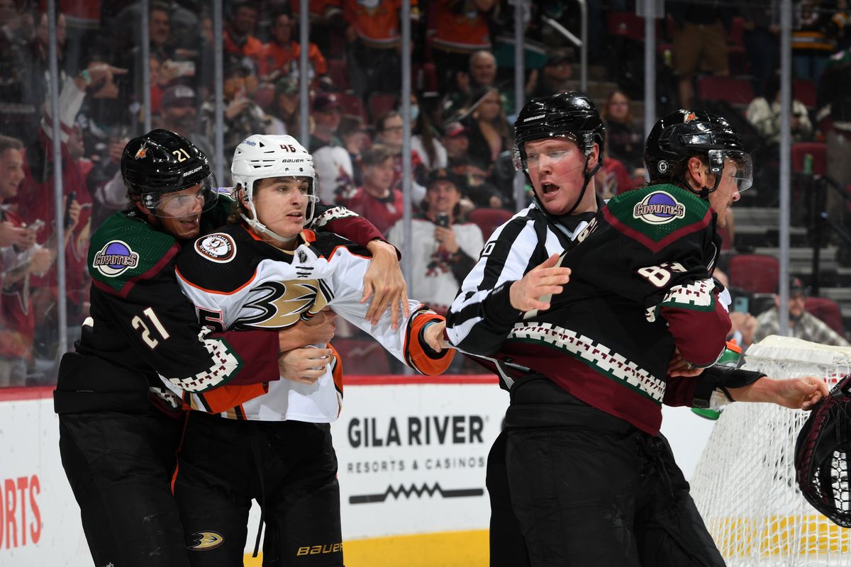 Trevor Zegras (second from left) is held back during a scuffle.