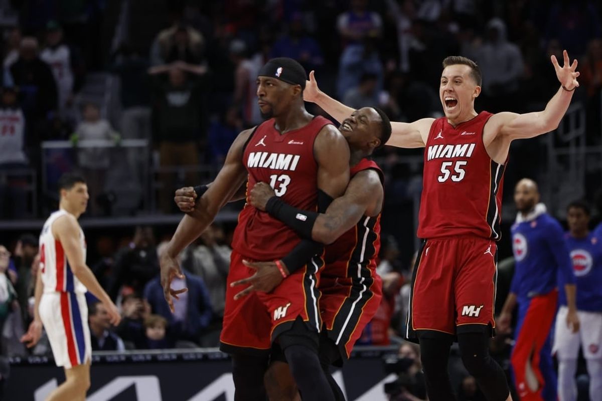 Mar 17, 2024; Detroit, Michigan, USA;  Miami Heat center Bam Adebayo (13) celebrates with guard Terry Rozier (2) and forward Duncan Robinson (55) after he hits a three point basket as time ran out to win the game against the Detroit Pistons at Little Caesars Arena.