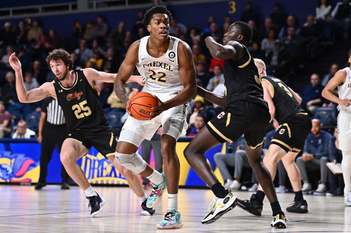 Feb 2, 2023; Philadelphia, Pennsylvania, USA; Drexel Dragons forward Amari Williams (22) drives against Charleston Cougars forward Babacar Faye (35) in the second half at Daskalakis Athletic Center.