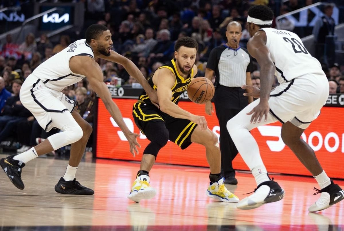 Dec 16, 2023; San Francisco, California, USA; Golden State Warriors guard Stephen Curry (30) controls the ball against Brooklyn Nets guard Mikal Bridges (1) and center Day'Ron Sharpe (20) during the second quarter at Chase Center.