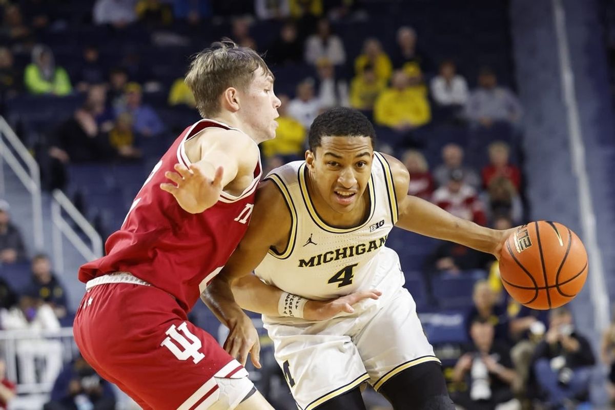 Dec 5, 2023; Ann Arbor, Michigan, USA;  Michigan Wolverines guard Nimari Burnett (4) dribbles against Indiana Hoosiers guard Gabe Cupps (2) in the first half at Crisler Center.