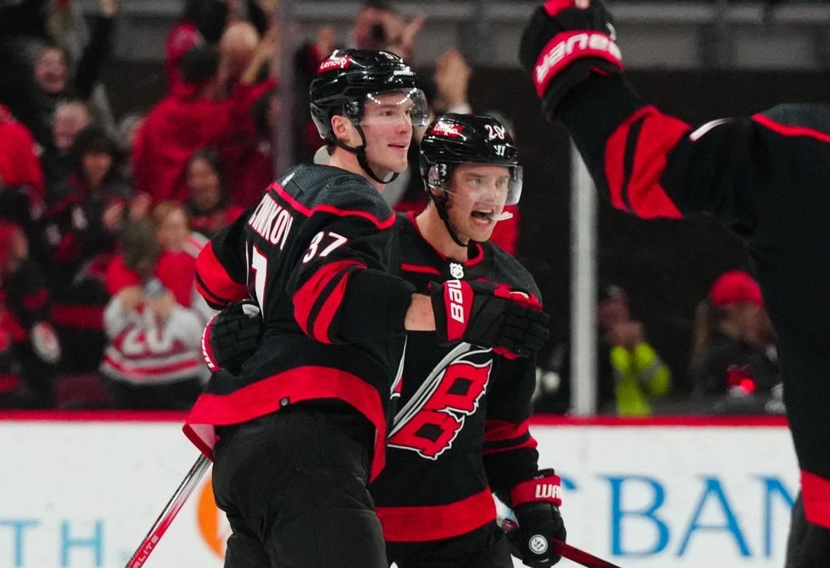Feb 22, 2024; Raleigh, North Carolina, USA; Carolina Hurricanes center Sebastian Aho (20) is congratulated by right wing Andrei Svechnikov (37) after his goal against the Florida Panthers during the third period at PNC Arena.