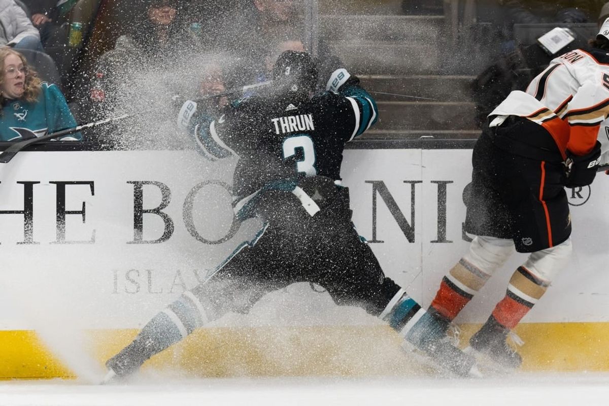 Feb 29, 2024; San Jose, California, USA; San Jose Sharks defenseman Henry Thrun (3) collides into the wall during the first period against the Anaheim Ducks at SAP Center at San Jose.