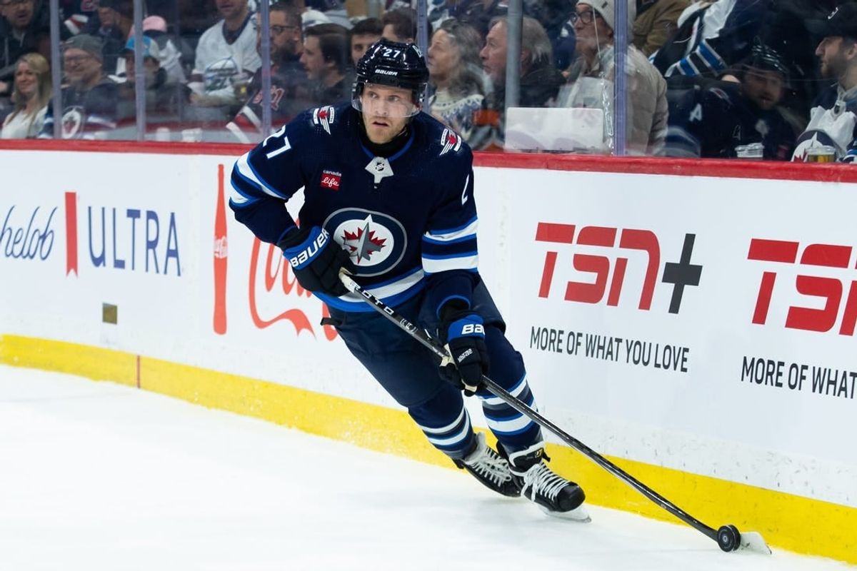 Jan 16, 2024; Winnipeg, Manitoba, CAN; Winnipeg Jets forward Nikolaj Ehlers (27) looks to make a pass against the New York Islanders during the first period at Canada Life Centre.