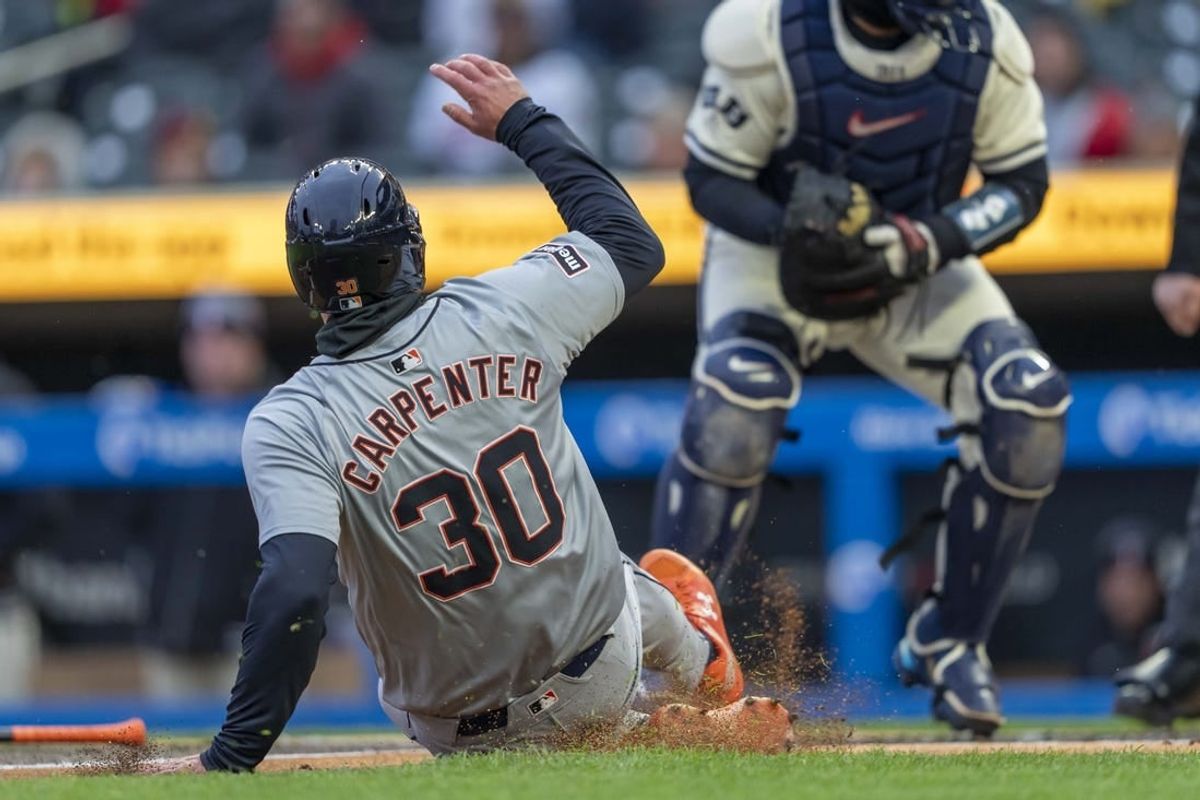 Apr 19, 2024; Minneapolis, Minnesota, USA; Detroit Tigers left fielder Kerry Carpenter (30) slides into home plate for a run against the Minnesota Twins in the first inning at Target Field.