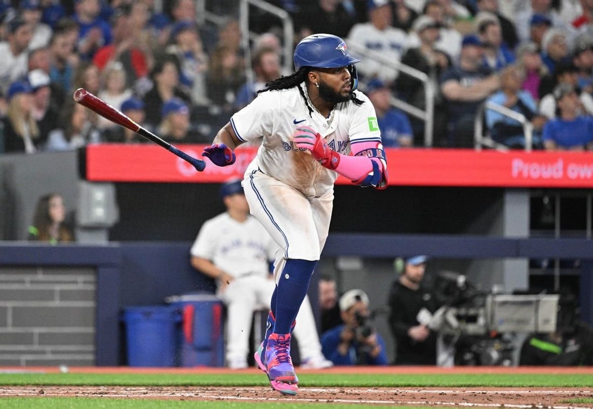 Apr 8, 2024; Toronto, Ontario, CAN;  Toronto Blue Jays first baseman Vladimir Guerrero Jr. (27) hits an RBI double against the Seattle Mariners in the fourth inning at Rogers Centre.