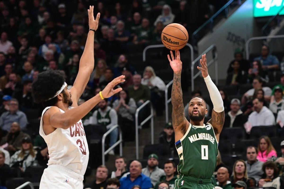 Jan 24, 2024; Milwaukee, Wisconsin, USA;  Milwaukee Bucks guard Damian Lillard (0) takes a shot against Cleveland Cavaliers center Jarrett Allen (31) in the first quarter at Fiserv Forum.