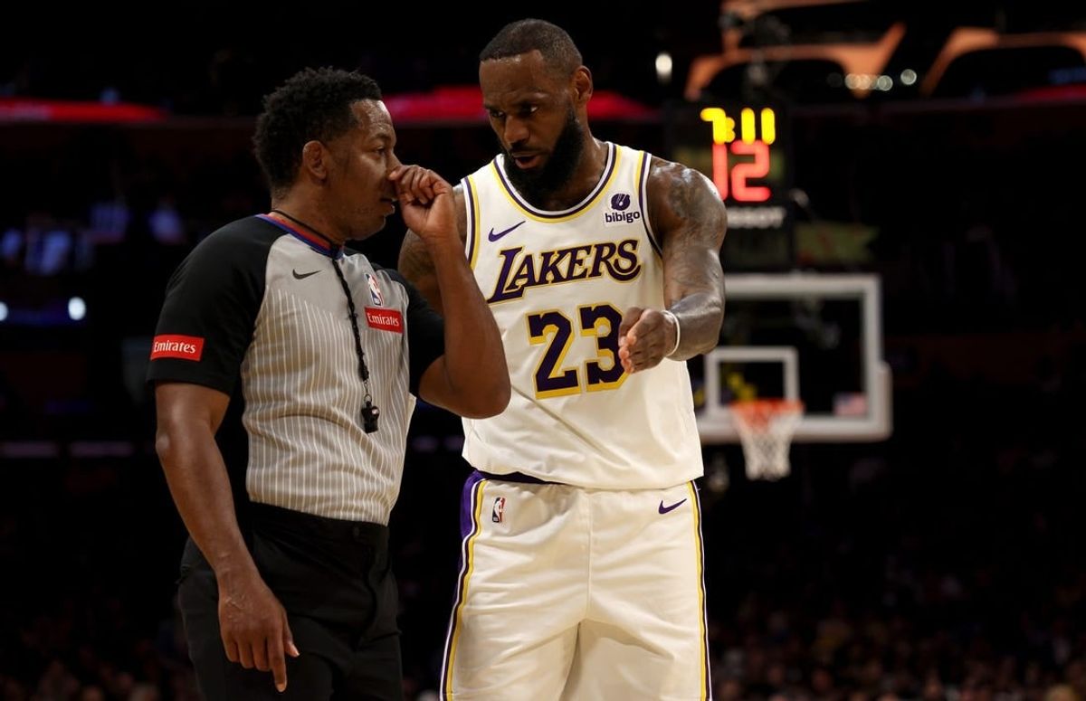 Mar 16, 2024; Los Angeles, California, USA; Los Angeles Lakers forward LeBron James (23) talks to referee Mitchell Ervin (27) during the second quarter against the Golden State Warriors at Crypto.com Arena.