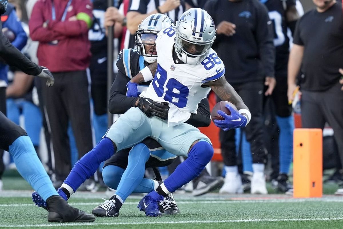 Nov 19, 2023; Charlotte, North Carolina, USA;  Dallas Cowboys wide receiver CeeDee Lamb (88) is hit as he makes a catch by Carolina Panthers safety Vonn Bell (24) during the second half at Bank of America Stadium.