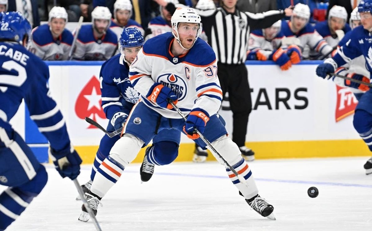 Mar 23, 2024; Toronto, Ontario, CAN; Edmonton Oilers forward Connor McDavid (97) passes the puck against the Toronto Maple Leafs in the second period at Scotiabank Arena.