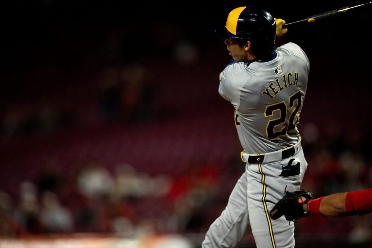 Milwaukee Brewers designated hitter Christian Yelich (22) hits a 2-run home run in the first inning of the MLB baseball game between Milwaukee Brewers and Cincinnati Reds at Great American Ball Park in Cincinnati on Wednesday, April 10, 2024.