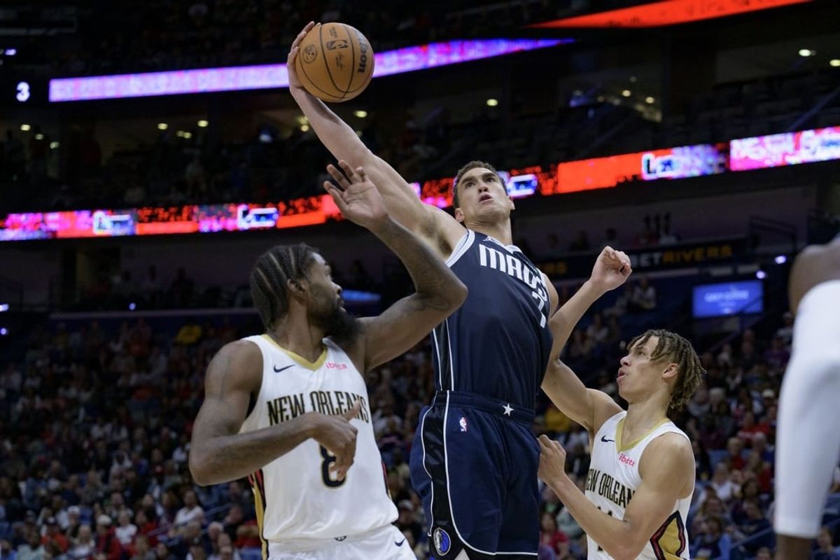 Nov 12, 2023; New Orleans, Louisiana, USA; Dallas Mavericks center Dwight Powell (7) grabs a rebound between New Orleans Pelicans forward Naji Marshall (8) and guard Dyson Daniels (11) during the first half at the Smoothie King Center.