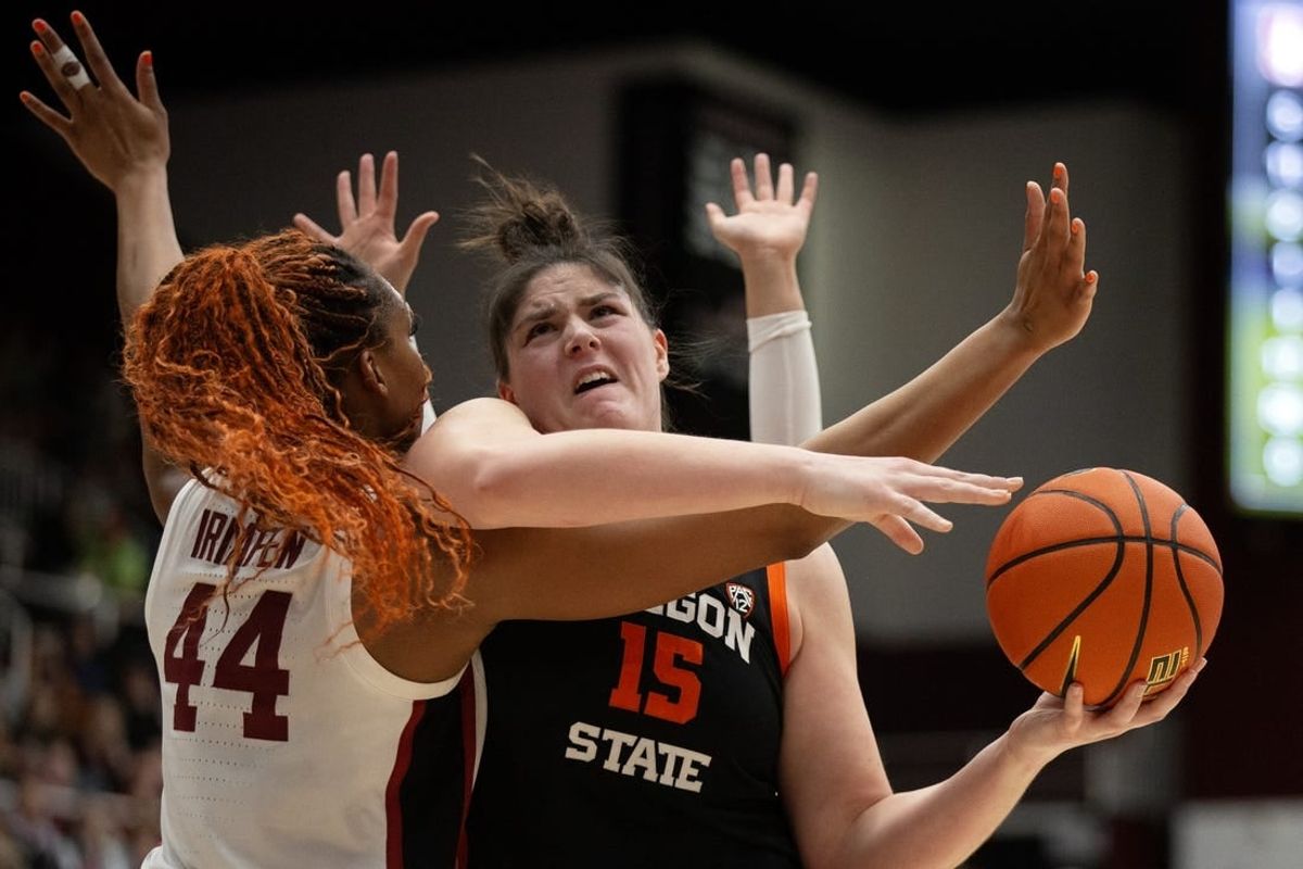 Jan 21, 2024; Stanford, California, USA; Oregon State Beavers forward Raegan Beers (15) tries to shoot over Stanford Cardinal forward Kiki Iriafen (44) during the first quarter at Maples Pavilion.