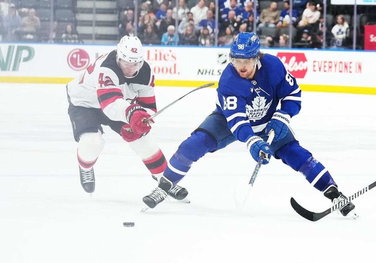 Mar 26, 2024; Toronto, Ontario, CAN; Toronto Maple Leafs right wing William Nylander (88) battles for the puck with New Jersey Devils defenseman Brendan Smith (2) during the third period at Scotiabank Arena.