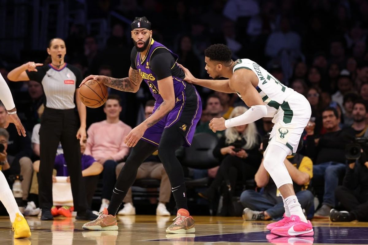 Mar 8, 2024; Los Angeles, California, USA;  Los Angeles Lakers forward Anthony Davis (3) posts up against Milwaukee Bucks forward Giannis Antetokounmpo (34) during the first quarter at Crypto.com Arena.