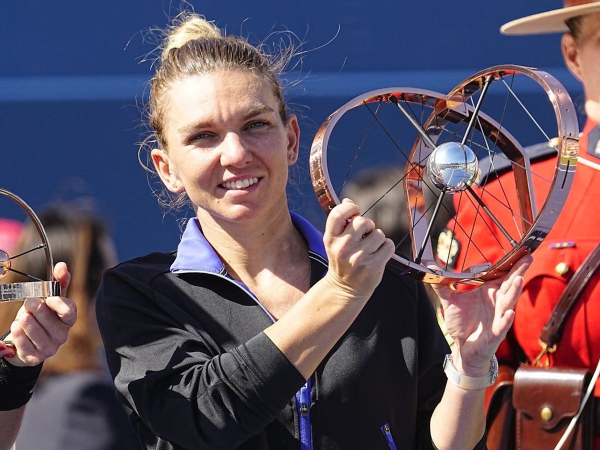 Aug 14, 2022; Toronto, ON, Canada; Simona Halep (ROU) poses with the National Bank Open trophy after defeating Beatriz Haddad Maia (not pictured)  in the women's final of the National Bank Open at Sobeys Stadium.