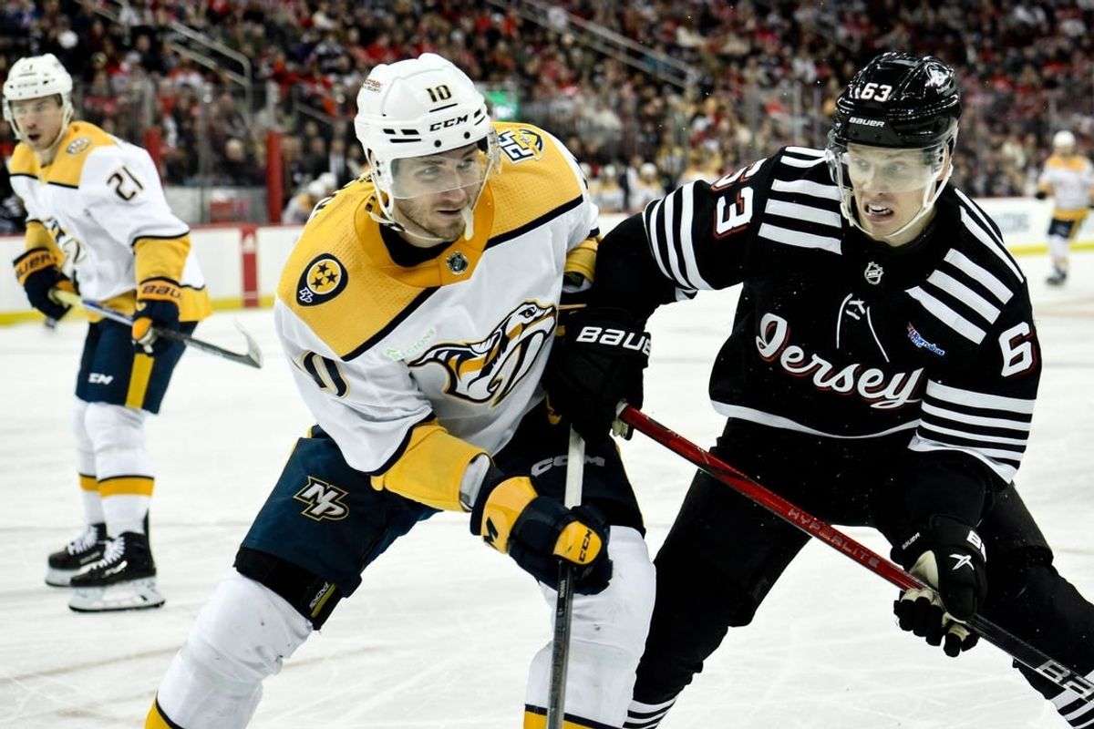 Apr 7, 2024; Newark, New Jersey, USA; Nashville Predators center Colton Sissons (10) and New Jersey Devils left wing Jesper Bratt (63) compete for the puck during the second period at Prudential Center.