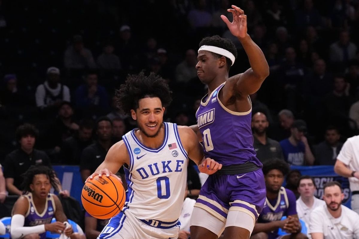 Mar 24, 2024; Brooklyn, NY, USA; Duke Blue Devils guard Jared McCain (0) dribbles the ball past James Madison Dukes guard Xavier Brown (0) in the second round of the 2024 NCAA Tournament  at Barclays Center.