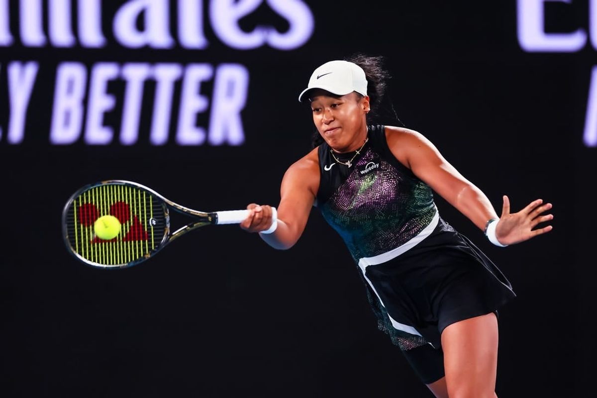 Jan 15, 2024; Melbourne, Victoria, Australia; Naomi Osaka of Japan plays a shot against Caroline Garcia (not pictured) of France in Round 1 of the Women's Singles on Day 2 of the Australian Open tennis at Rod Laver Arena.