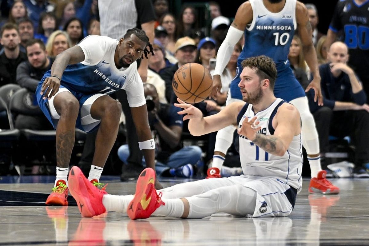 Jan 7, 2024; Dallas, Texas, USA; Dallas Mavericks guard Luka Doncic (77) passes the ball in front of Minnesota Timberwolves center Naz Reid (11) during the second quarter at the American Airlines Center.