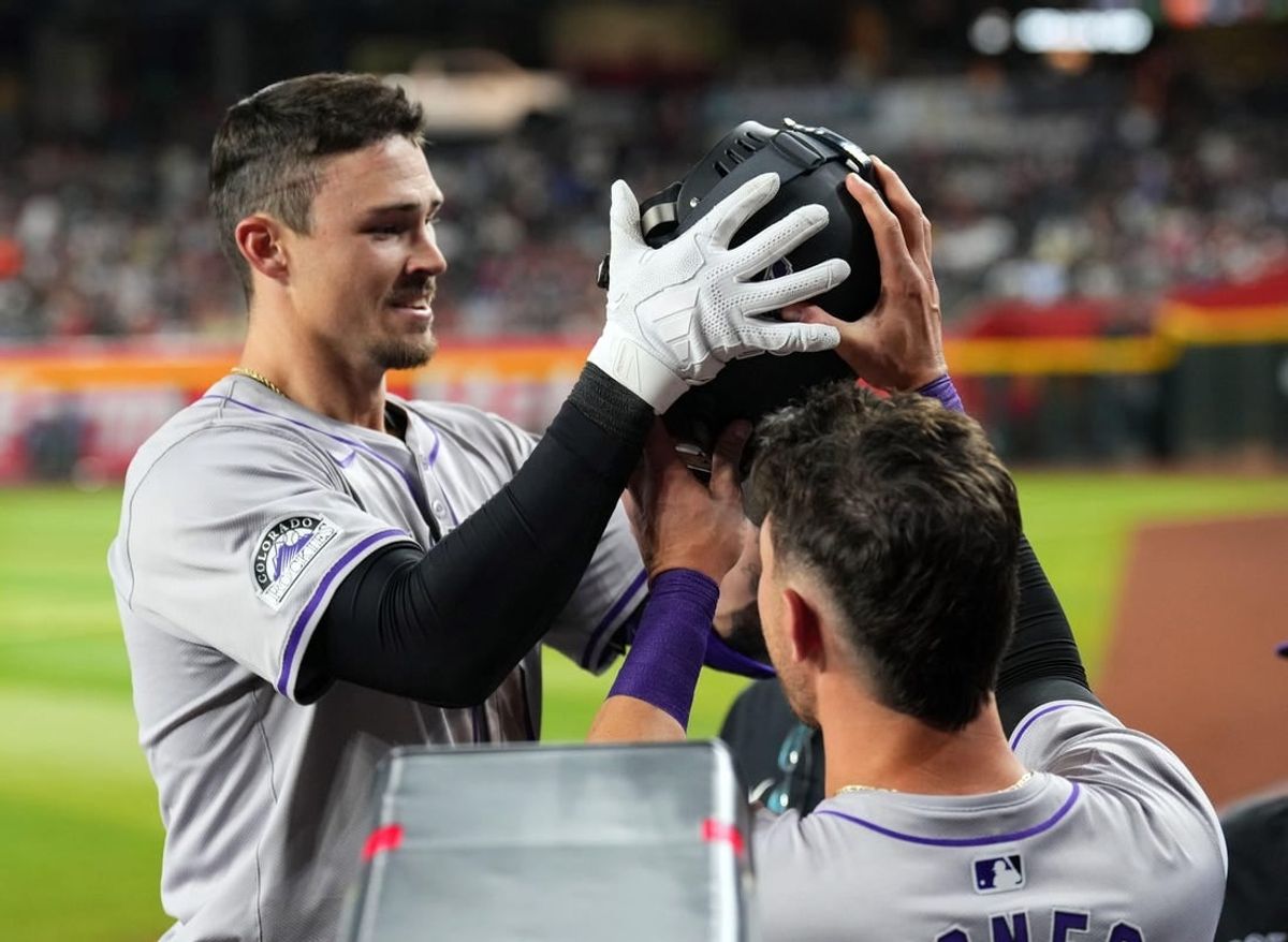 Mar 30, 2024; Phoenix, Arizona, USA; Colorado Rockies center fielder Brenton Doyle (9) celebrates with teammates in the dugout after hitting a two run home run against the Arizona Diamondbacks during the eighth inning at Chase Field.