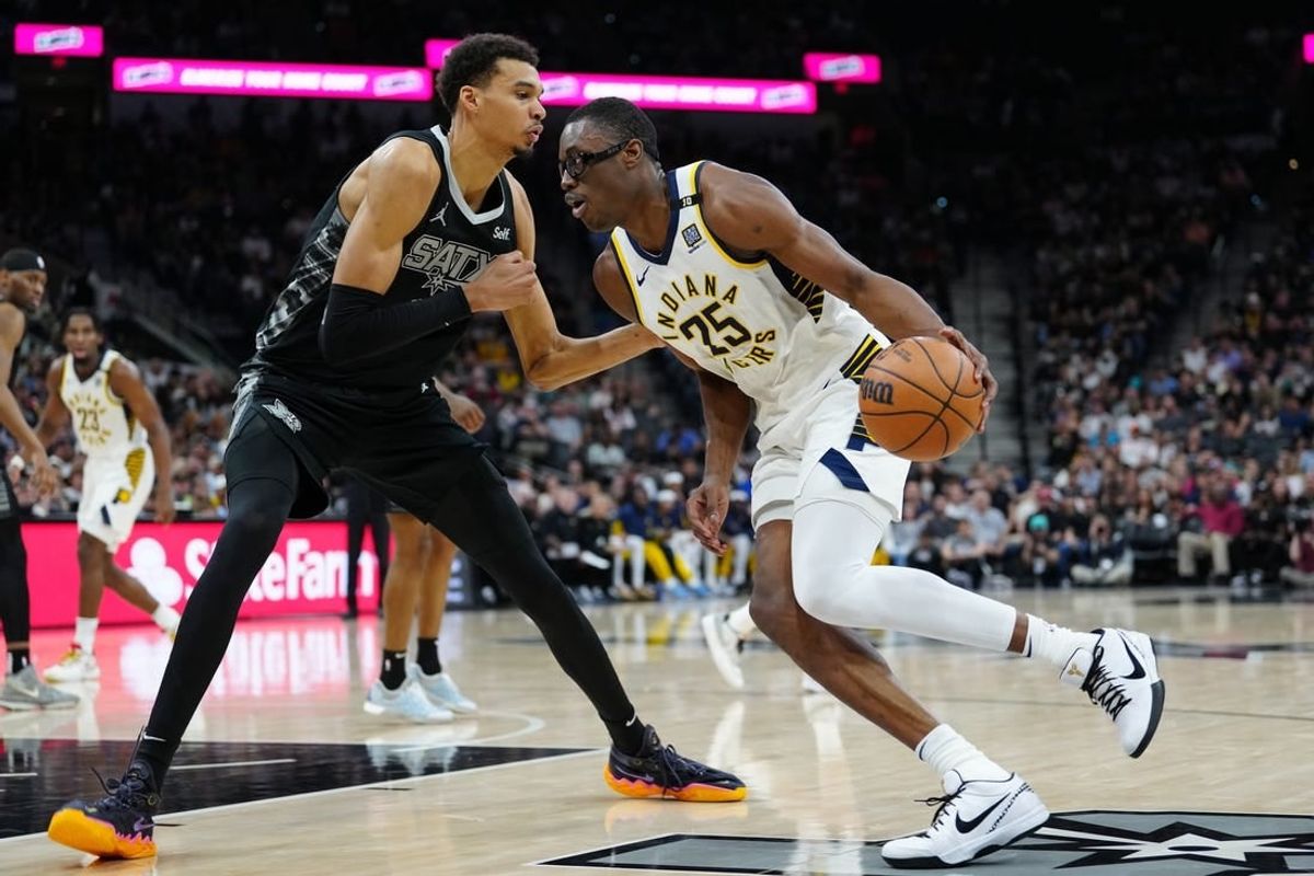 Mar 3, 2024; San Antonio, Texas, USA; Indiana Pacers forward Jalen Smith (25) dribbles against San Antonio Spurs center Victor Wembanyama (1) in the first half at Frost Bank Center.