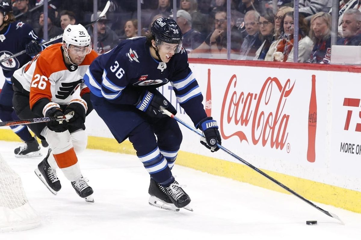 Jan 13, 2024; Winnipeg, Manitoba, CAN; Winnipeg Jets center Morgan Barron (36) is chased down by Philadelphia Flyers defenseman Sean Walker (26) in the second period at Canada Life Centre.