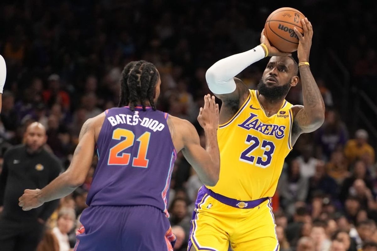 Nov 10, 2023; Phoenix, Arizona, USA; Los Angeles Lakers forward LeBron James (23) shoots against Phoenix Suns forward Keita Bates-Diop (21) in the first half at Footprint Center.