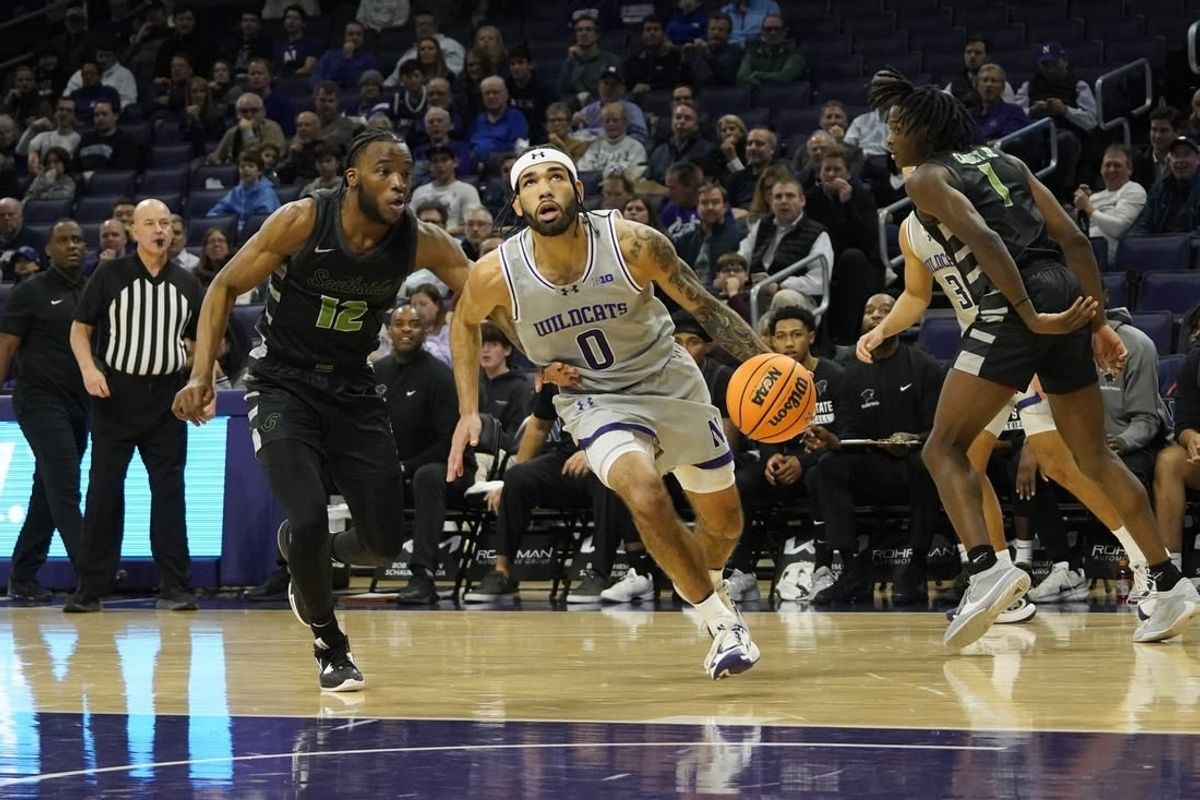 Dec 13, 2023; Evanston, Illinois, USA; Chicago State Cougars guard Brent Davis (12) defends Northwestern Wildcats guard Boo Buie (0) during the first half at Welsh-Ryan Arena.