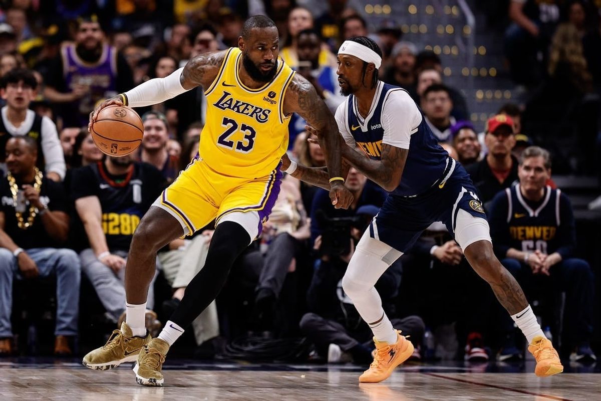 Apr 29, 2024; Denver, Colorado, USA; Los Angeles Lakers forward LeBron James (23) controls the ball as Denver Nuggets guard Kentavious Caldwell-Pope (5) guards in the third quarter during game five of the first round for the 2024 NBA playoffs at Ball Arena.