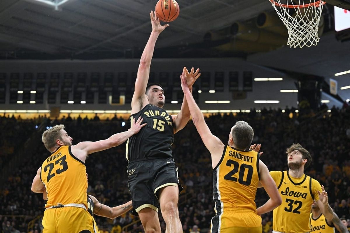Jan 20, 2024; Iowa City, Iowa, USA; Purdue Boilermakers center Zach Edey (15) shoots the ball over Iowa Hawkeyes forward Ben Krikke (23) and forward Payton Sandfort (20) and forward Owen Freeman (32) during the second half at Carver-Hawkeye Arena.