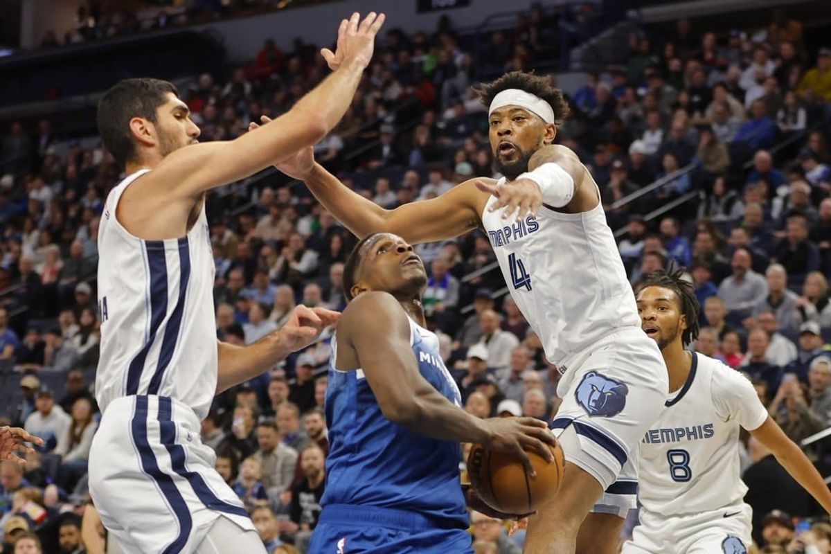 Feb 28, 2024; Minneapolis, Minnesota, USA; Minnesota Timberwolves guard Anthony Edwards (5) goes to the basket between Memphis Grizzlies forward Santi Aldama (7) and guard Jordan Goodwin (4) in the first quarter at Target Center.