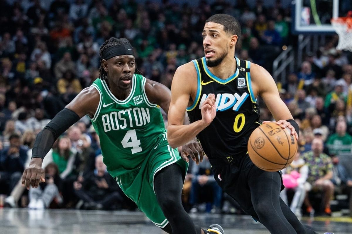 Jan 6, 2024; Indianapolis, Indiana, USA; Indiana Pacers guard Tyrese Haliburton (0) dribbles the ball against Boston Celtics guard Jrue Holiday (4) in the second half at Gainbridge Fieldhouse.
