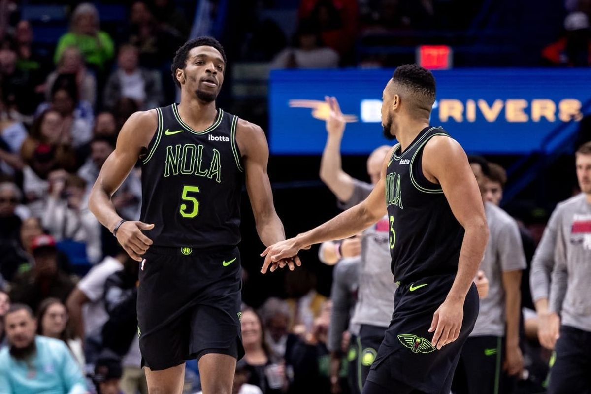 Mar 1, 2024; New Orleans, Louisiana, USA;  New Orleans Pelicans forward Herbert Jones (5) slaps hands with guard CJ McCollum (3) after a play against the Indiana Pacers during the first half at Smoothie King Center.