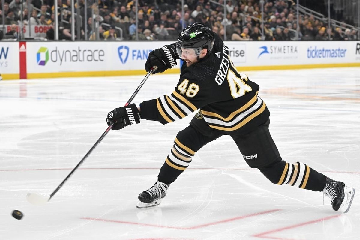 Feb 15, 2024; Boston, Massachusetts, USA; Boston Bruins defenseman Matt Grzelcyk (48) shoots the puck against the Seattle Kraken during the third period at the TD Garden.