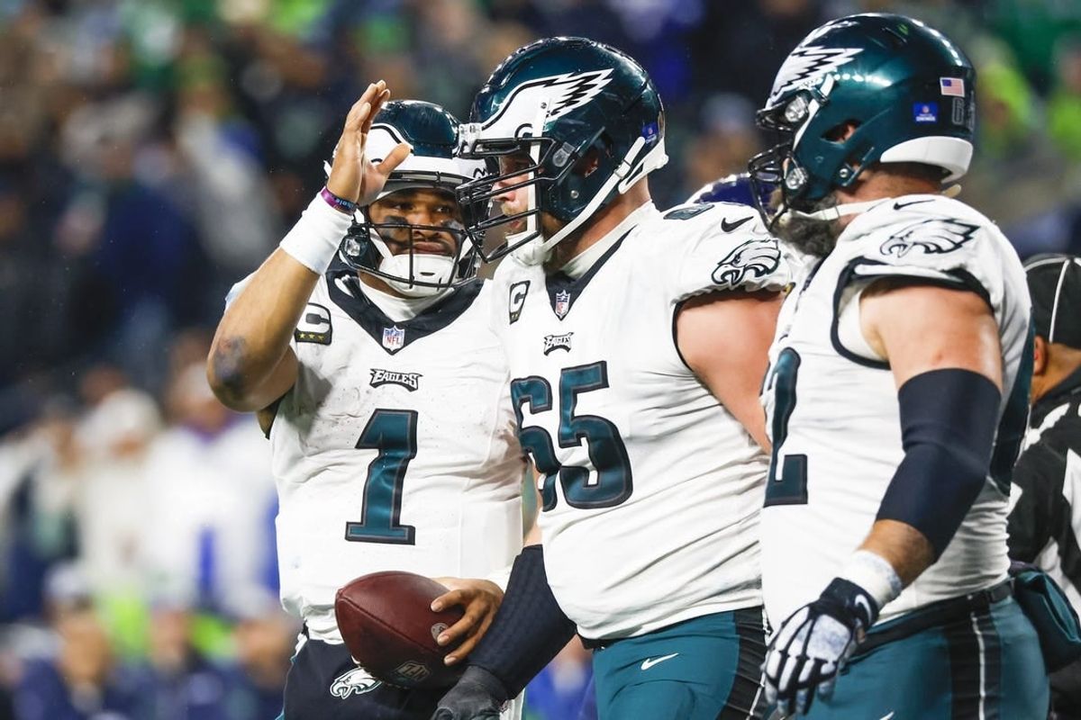 Dec 18, 2023; Seattle, Washington, USA; Philadelphia Eagles quarterback Jalen Hurts (1) pats offensive tackle Lane Johnson (65) on the head after rushing for a touchdown against the Seattle Seahawks during the third quarter at Lumen Field.