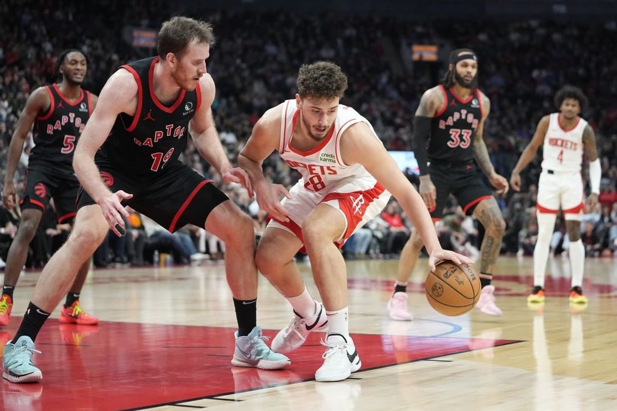 Feb 9, 2024; Toronto, Ontario, CAN; Houston Rockets center Alperen Sengun (28) controls the ball against Toronto Raptors center Jakob Poeltl (19) during the second half at Scotiabank Arena.