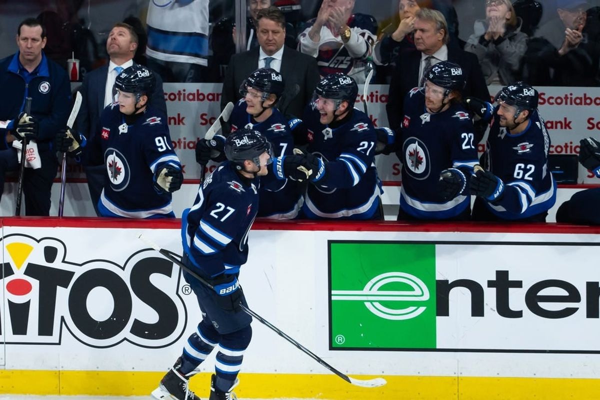 Jan 11, 2024; Winnipeg, Manitoba, CAN; Winnipeg Jets forward Nikolaj Ehlers (27) is congratulated by his team mates on his goal  against Chicago Blackhawks goalie Petr Mrazek (34) during the third period at Canada Life Centre.