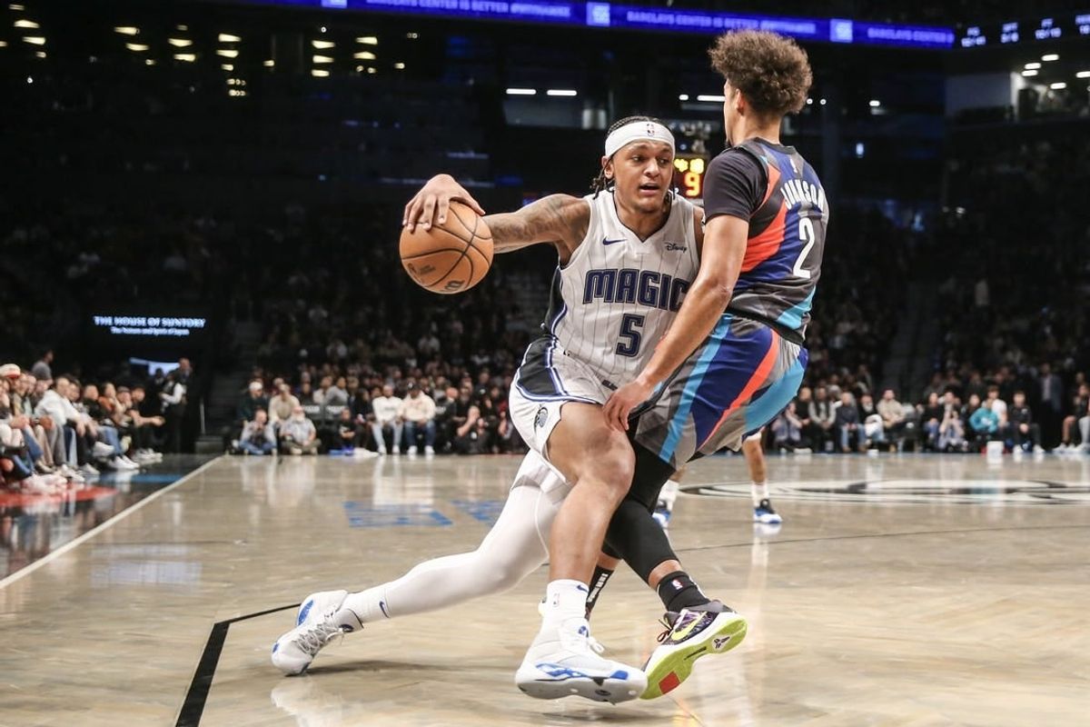 Dec 2, 2023; Brooklyn, New York, USA;  Orlando Magic forward Paolo Banchero (5) collides with Brooklyn Nets forward Cameron Johnson (2) in the second quarter at Barclays Center.
