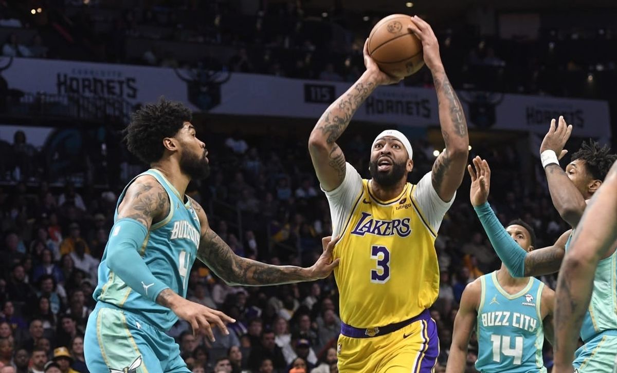 Feb 5, 2024; Charlotte, North Carolina, USA;  Los Angeles Lakers forward Anthony Davis (3) looks to pass as he is defended by Charlotte Hornets center Nick Richards (4) during the first half at the Spectrum Center.