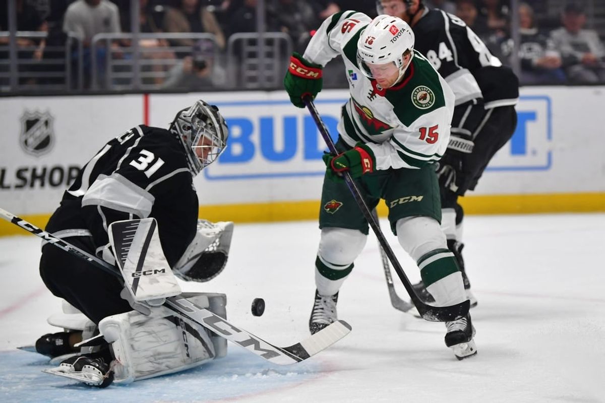 Mar 20, 2024; Los Angeles, California, USA; Los Angeles Kings goaltender David Rittich (31) blocks a shot against Minnesota Wild center Mason Shaw (15) during the first period at Crypto.com Arena.