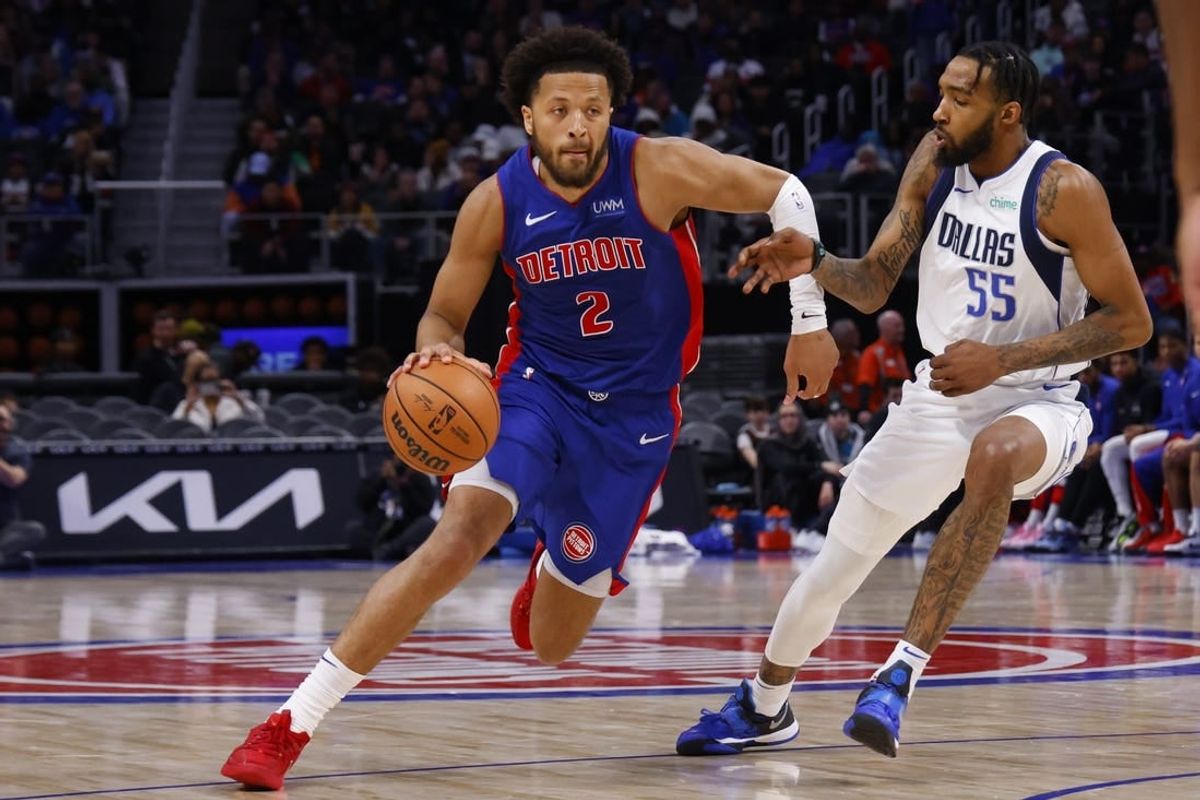 Mar 9, 2024; Detroit, Michigan, USA;  Detroit Pistons guard Cade Cunningham (2) dribbles defended by Dallas Mavericks forward Derrick Jones Jr. (55) in the second half at Little Caesars Arena.