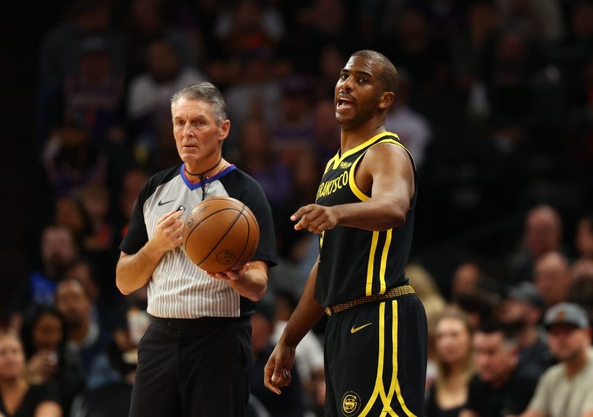 Nov 22, 2023; Phoenix, Arizona, USA; Golden State Warriors guard Chris Paul (3) alongside NBA referee Scott Foster against the Phoenix Suns in the first half at Footprint Center.