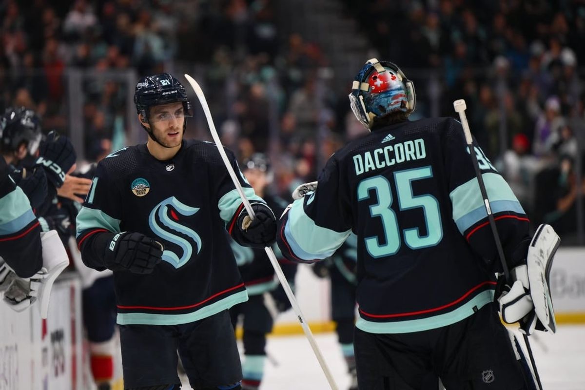 Dec 12, 2023; Seattle, Washington, USA; Seattle Kraken center Alex Wennberg (21) and goaltender Joey Daccord (35) celebrate after Wennberg scored a goal against the Florida Panthers during the third period at Climate Pledge Arena.