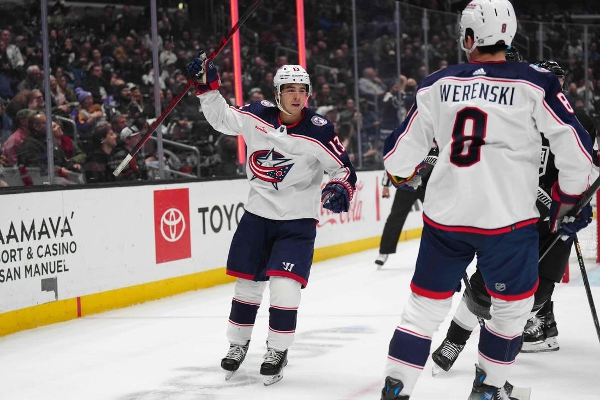 Feb 20, 2024; Los Angeles, California, USA; Columbus Blue Jackets left wing Johnny Gaudreau (13) celebrates with defenseman Zach Werenski (8) against the LA Kings in the first period at Crypto.com Arena.