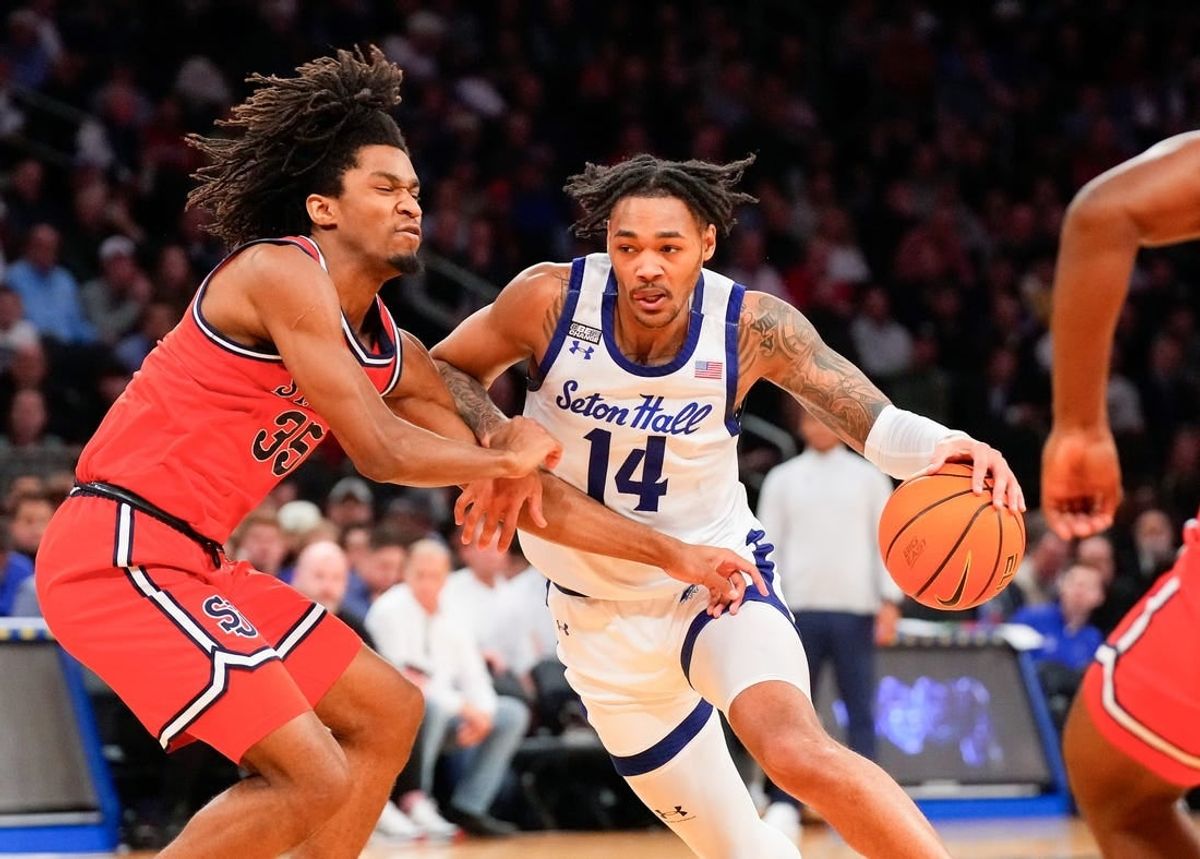 Mar 14, 2024; New York City, NY, USA;  Seton Hall Pirates guard Dre Davis (14) drives on St. John's Red Storm forward Glenn Taylor Jr. (35) during the first half at Madison Square Garden.