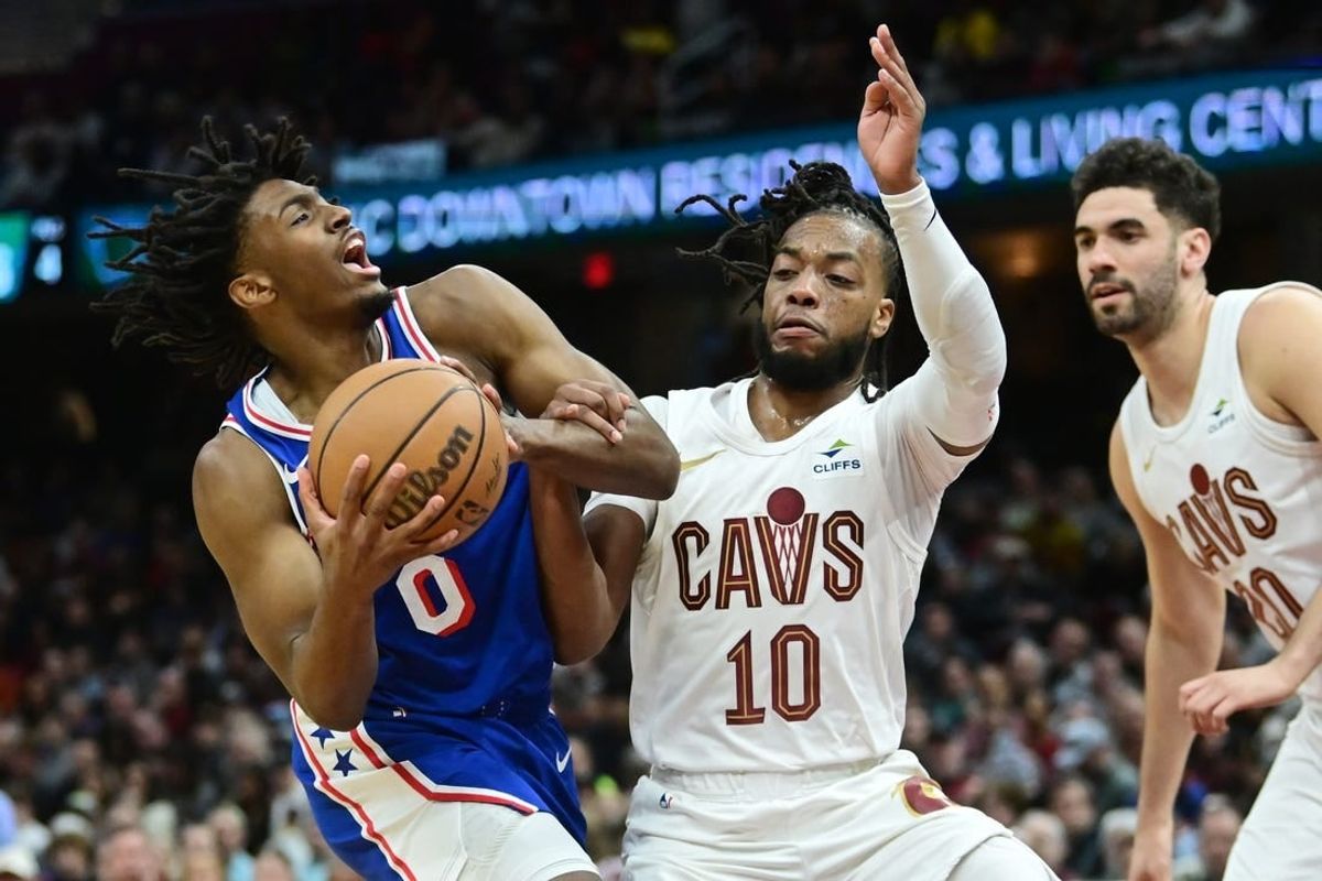 Mar 29, 2024; Cleveland, Ohio, USA; Philadelphia 76ers guard Tyrese Maxey (0) drives to the basket against Cleveland Cavaliers guard Darius Garland (10) during the first half at Rocket Mortgage FieldHouse.