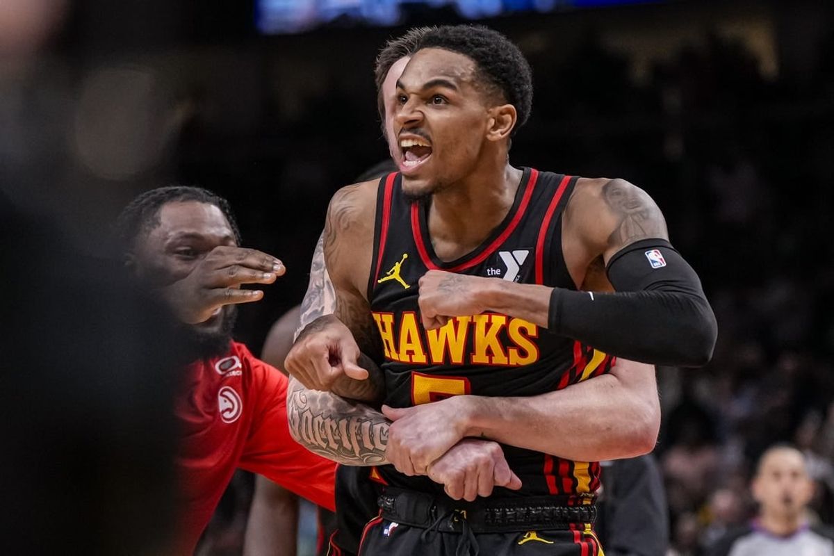 Mar 28, 2024; Atlanta, Georgia, USA; Atlanta Hawks guard Dejounte Murray (5) reacts after making a go ahead basket with less than a second left against the Boston Celtics during overtime at State Farm Arena.